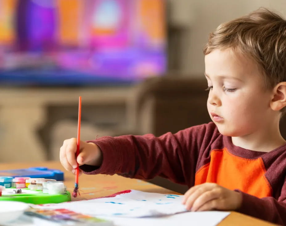 a child coloring on a paper