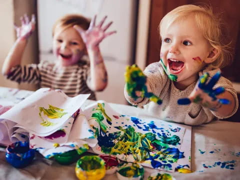 a little girl with her hands up