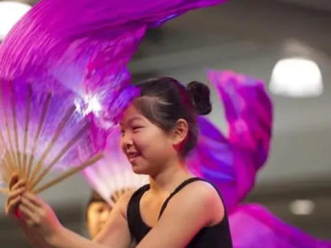 a woman holding a purple umbrella