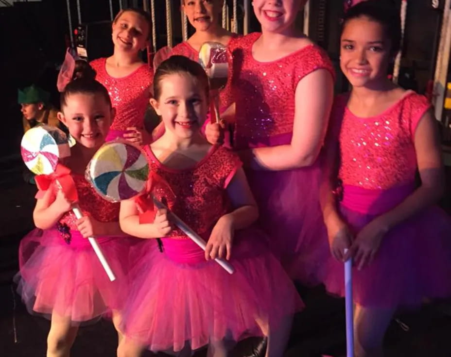 a group of girls in dresses