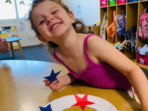 a girl smiling and holding a gift