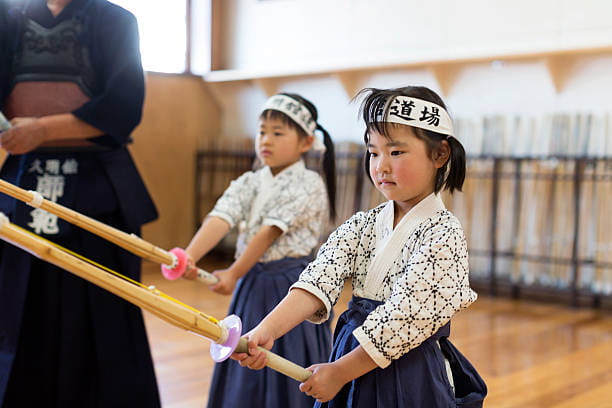 a group of children holding sticks