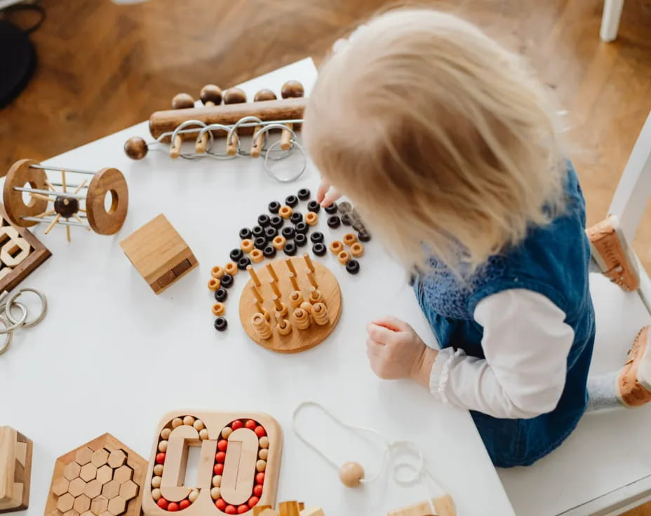 a child playing with wooden blocks