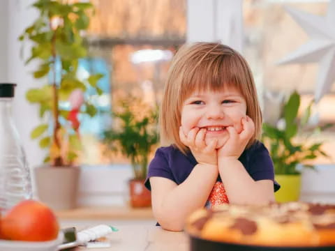 a little girl eating a cake