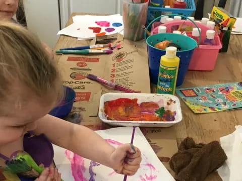 a child painting on a table