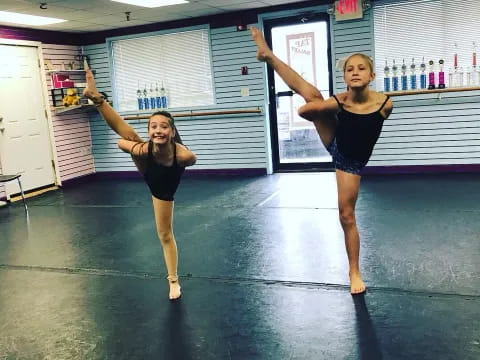 two women dancing in a gym