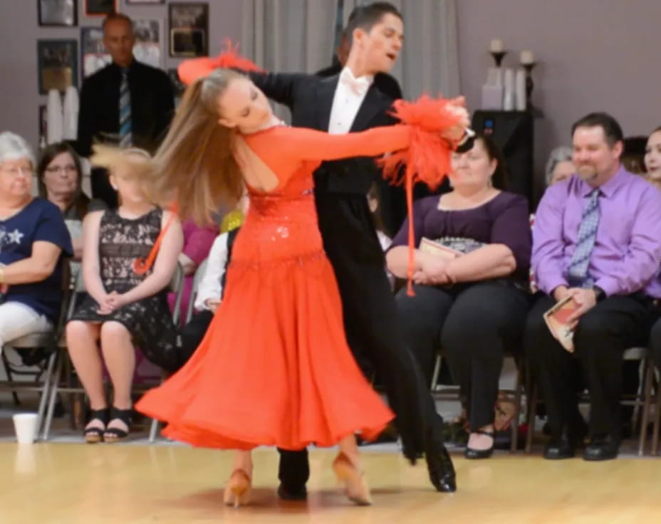 a girl dancing in a red dress