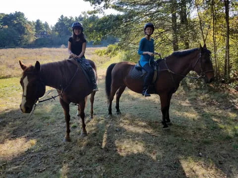 two people riding horses