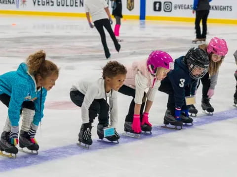 a group of kids wearing helmets and ice skates