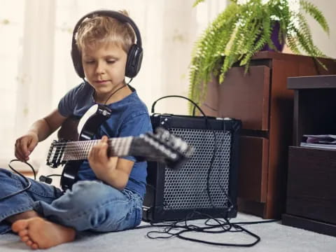 a boy playing a guitar