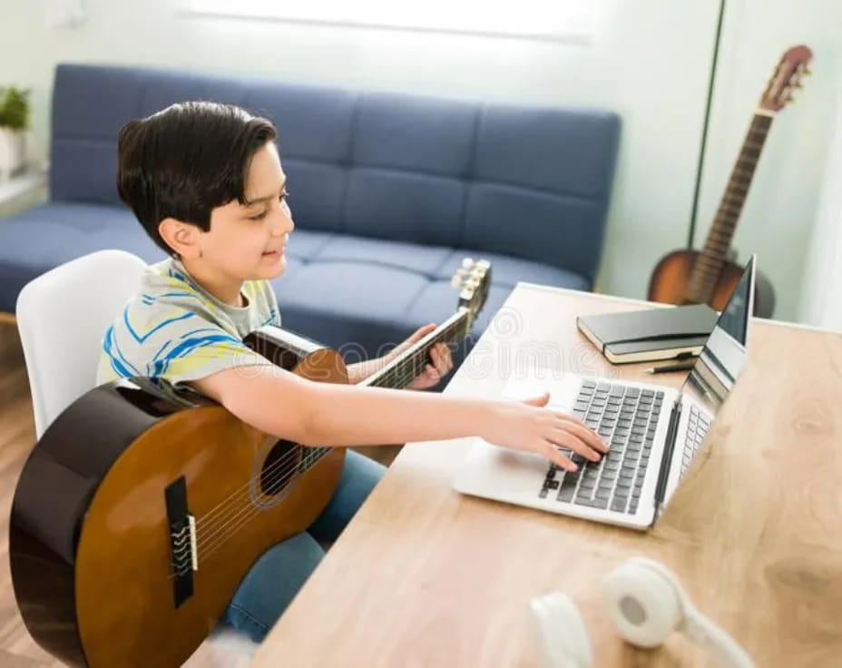 a person playing a guitar and a laptop