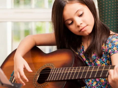 a woman playing a guitar