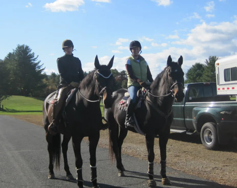 a couple of people ride on horses