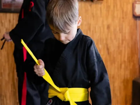 a boy holding a yellow umbrella