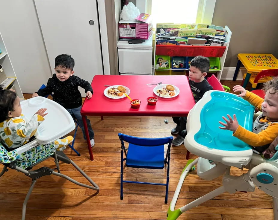 a group of kids eating at a table