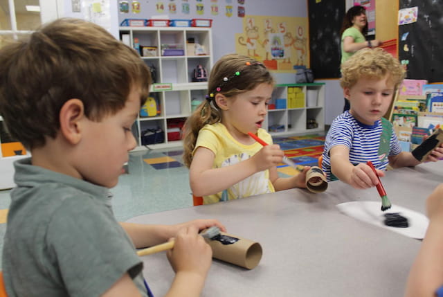a group of children playing with a toy