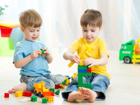 two boys playing with toys