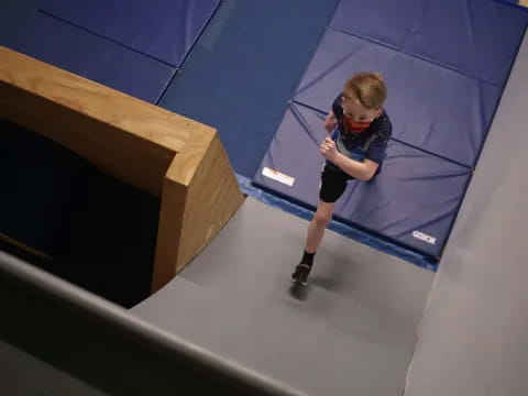 a boy in a blue tunnel