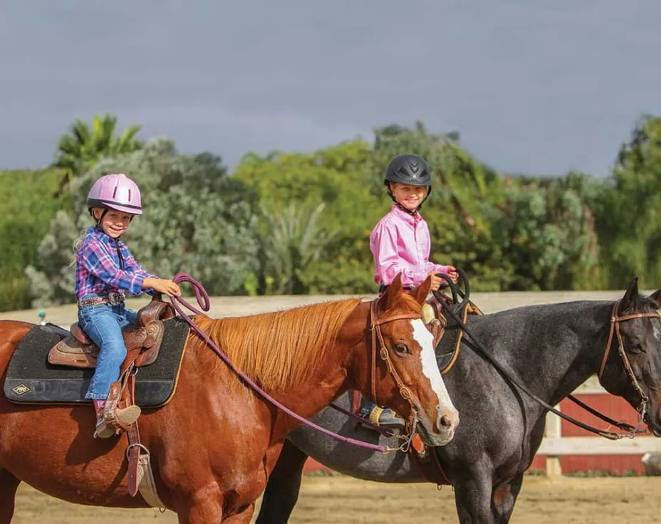 a couple of girls riding horses