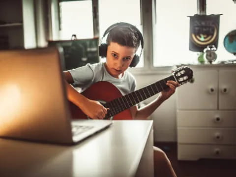 a child playing a guitar