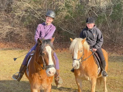a group of people ride horses