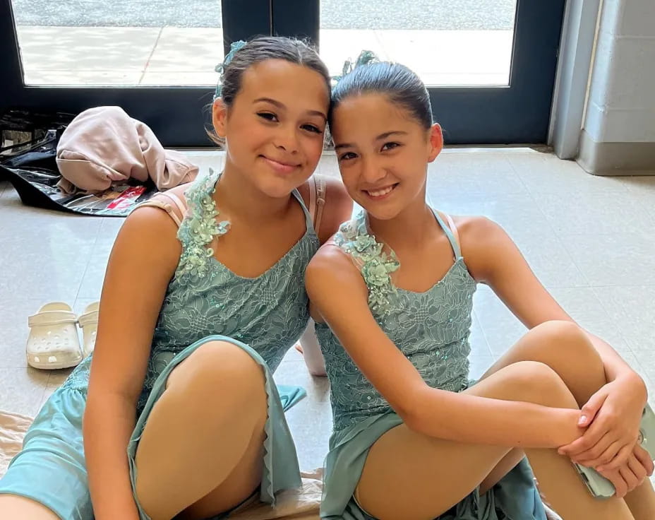 two girls sitting on the floor