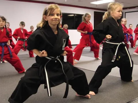 a group of women in black karate uniforms