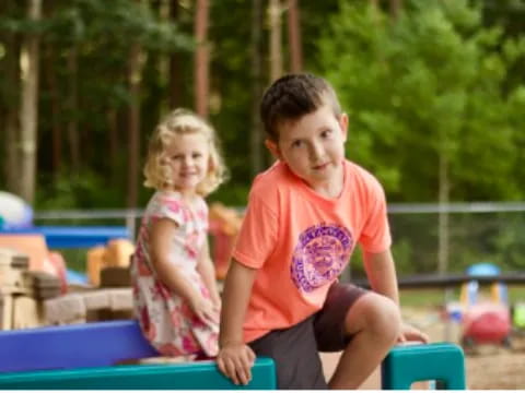 a boy and a girl on a playground