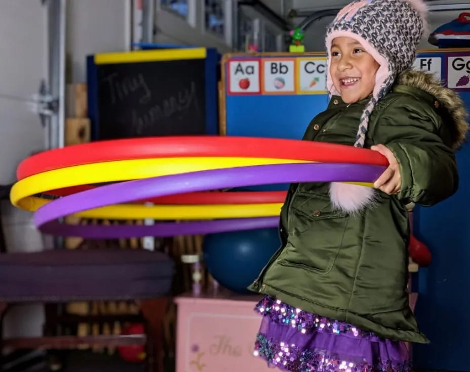 a person holding a rainbow colored object