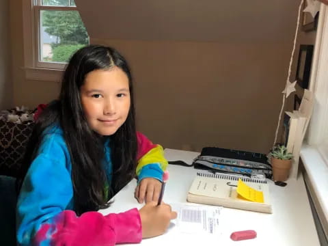 a girl sitting at a table