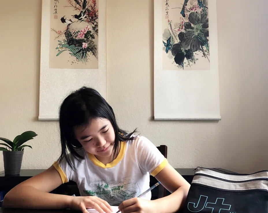 a girl sitting at a table