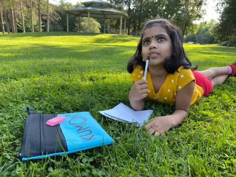 a girl sitting in the grass