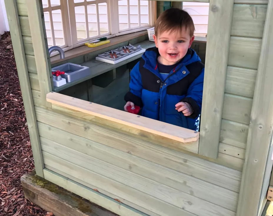 a boy in a wooden shed