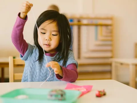 a girl painting on a table