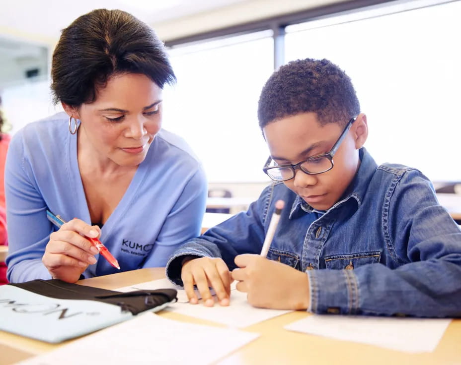 a man and a woman looking at a book