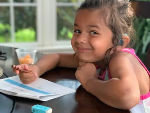 a girl sitting at a table