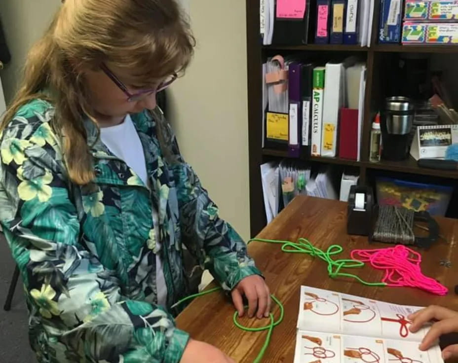 a woman painting on a table