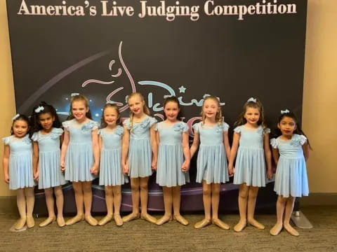 a group of girls in blue dresses