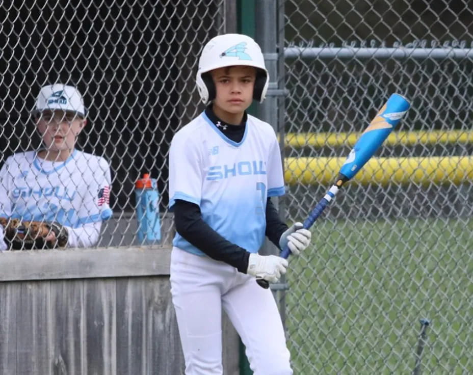 a young boy playing baseball