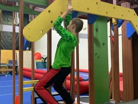 a boy climbing a slide
