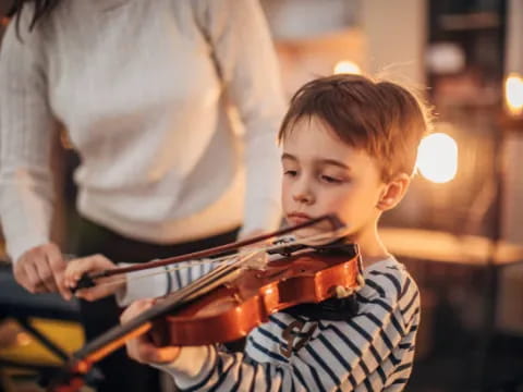 a boy playing a violin
