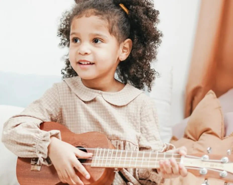 a child playing a guitar