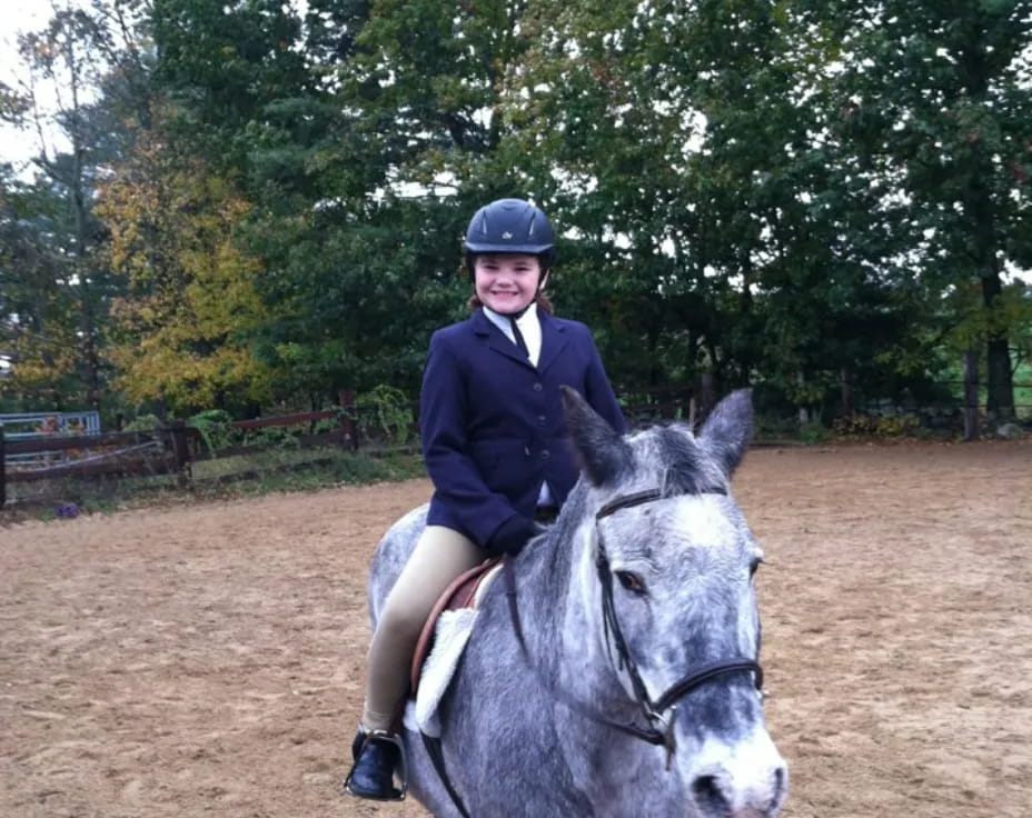 a girl riding a horse