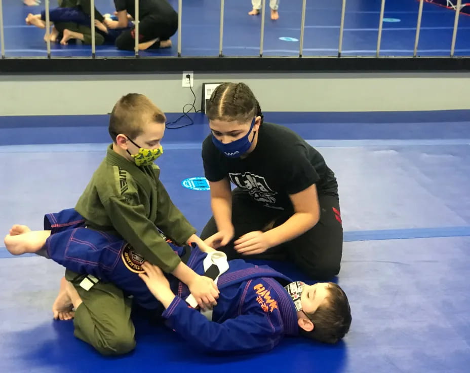a person helping a boy with a medal