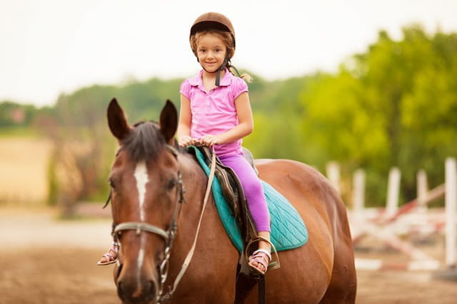 a girl riding a horse