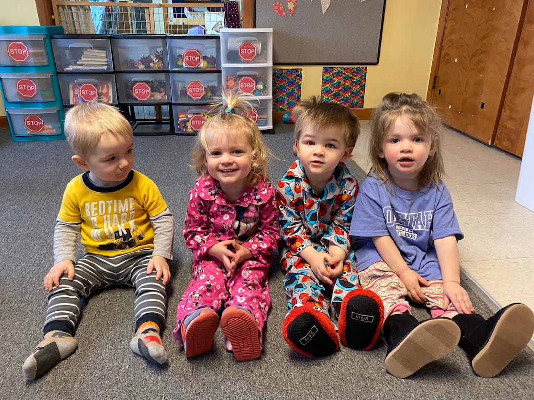 a group of children sitting on the floor