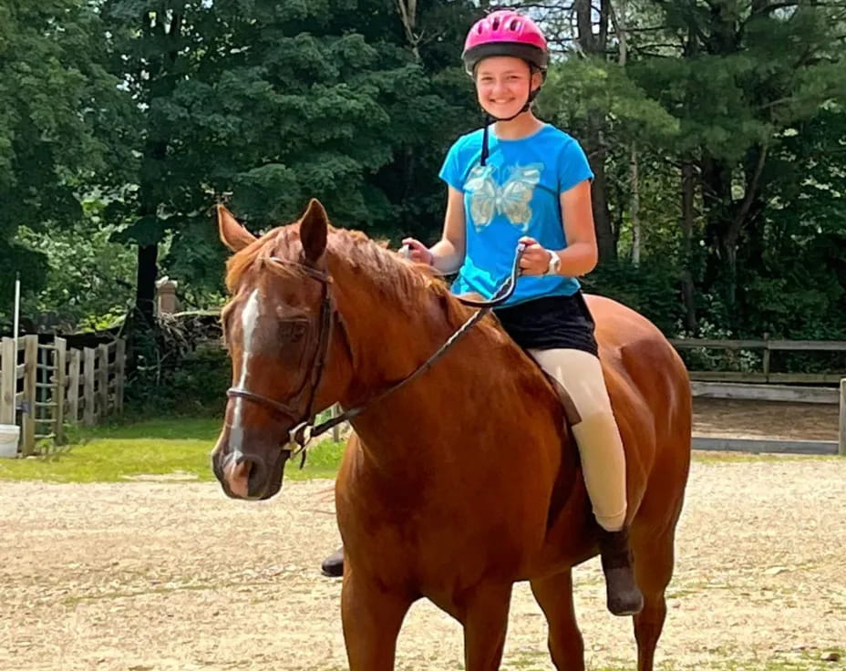a girl riding a horse