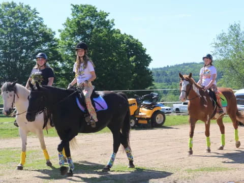 a group of people riding horses