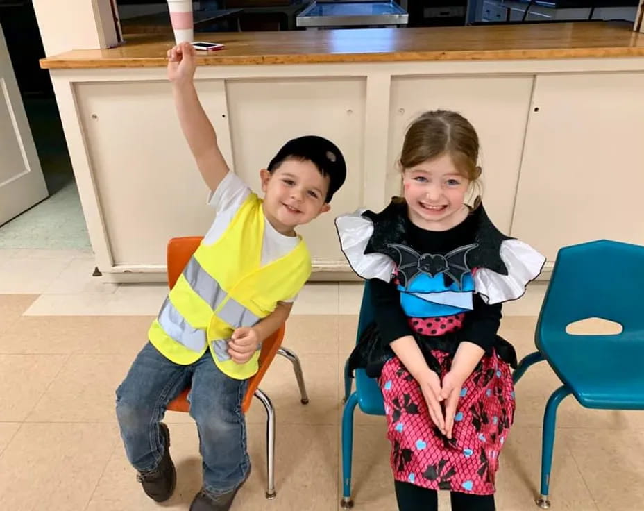 a boy and girl sitting in chairs