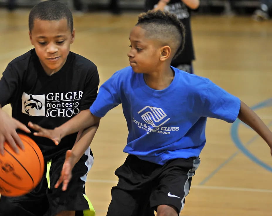 a couple of boys playing basketball